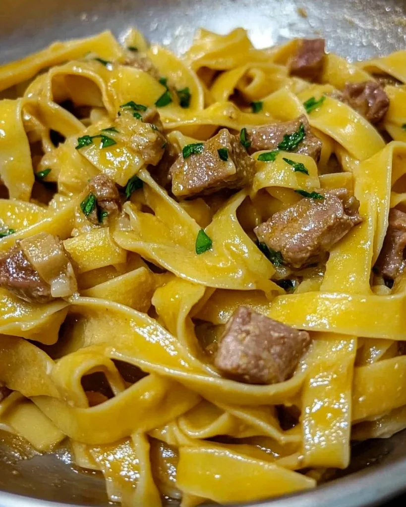 Pappardelle pasta with porcini mushrooms and sausage in a rich sauce
