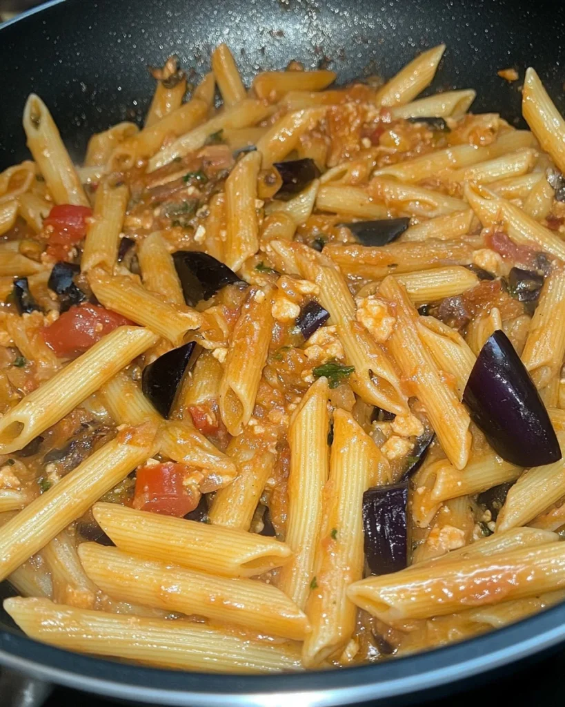 Delicious penne salsicce with eggplant dish served on a plate