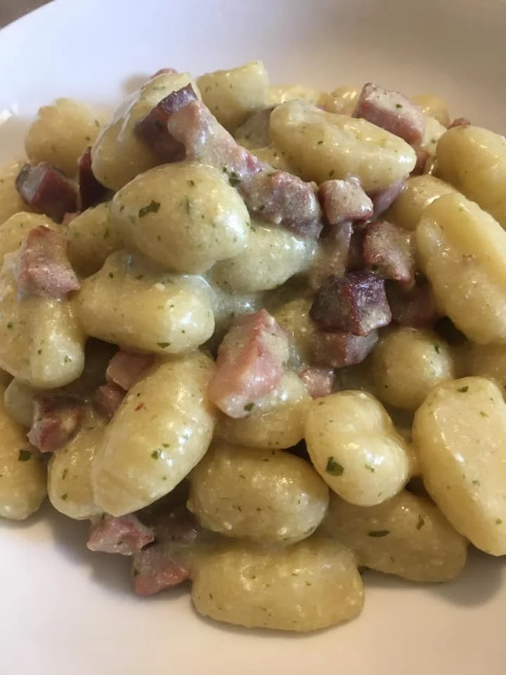 Gnocchi con Speck, Pesto e Robiola serviti in un piatto elegante