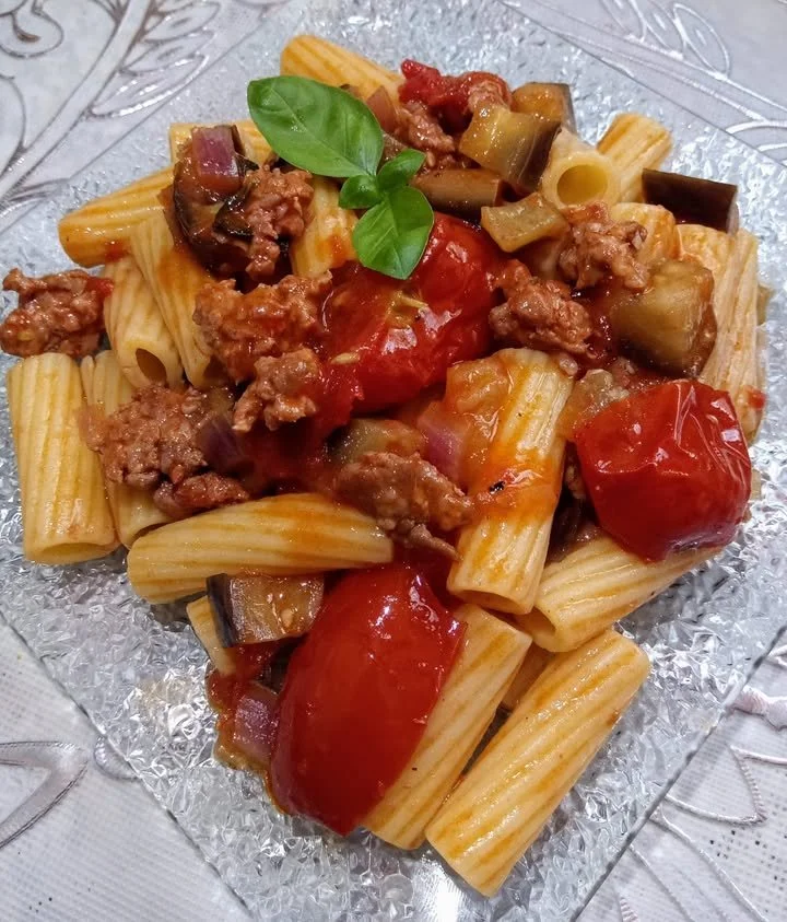Pasta with eggplant, cherry tomatoes, and sausage